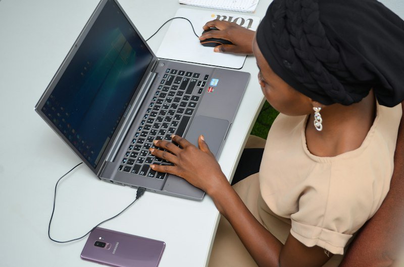 Professional preparing a project estimate on a laptop
